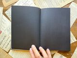 The Oracle Antiquarian Black Paper Notebook by The Creeping Moon